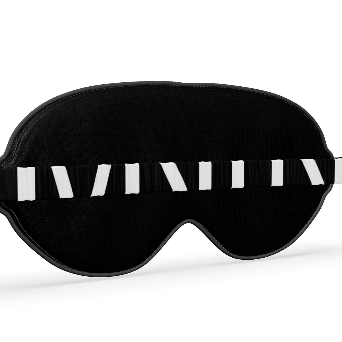 Angled detail of the back of the black eye mask and its MNTN logo band